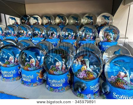 Orlando,fl/usa-1/17/20: A Shelf Of Manatee, Dolphin And Sea Turtle Souvenir Snowglobes  At Seaworld 