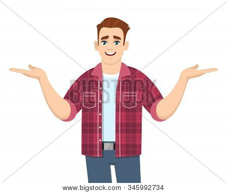 Stylish Young Man Showing Or Spreading Hands To Copy Space Side. Smiling Person In Trendy Casual Dre