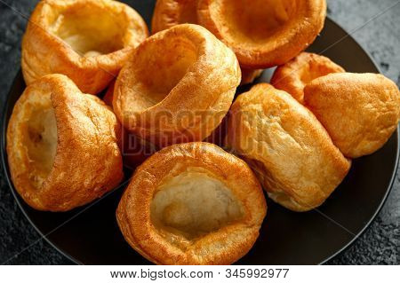 Traditional English Yorkshire Pudding Side Dish On Black Plate And Background