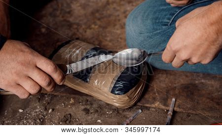 Two Shabby  Men Preparing Drug Injection In Slums.