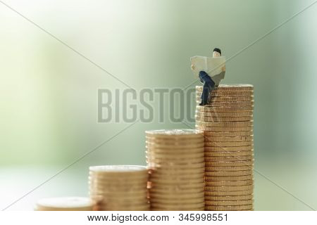 Money, Business, Saving And Planning Concept. Close Up Of Businessman Miniature Figure Perople Sitti