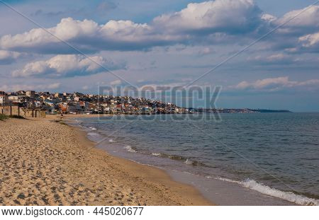 Fishing Port Beach In Sauvignon District Of Odessa, Ukraine. Warm Evening Sun, Blue Sea, Dramatic Cl