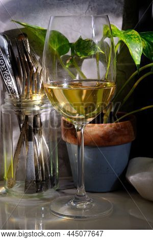 Natural Window Light Illuminates A Glass Of Pinot Grigio Seated On Marble Counter Top On Sunny After