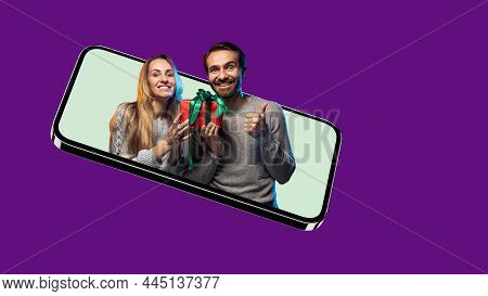 Crearive Collage Of Joyful Couple Sticking Out Phone Screen With Present Box Isolated Over Purple Ba