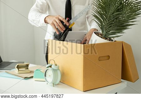 A Male Office Worker Is Unhappy With Being Fired From A Company Packing Things Into Cardboard Boxes.