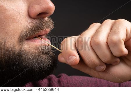 Closeup Bearded Man Clean Teeth From Food Stuck Teeth With Toothpick Eating. Rude Behavior. Uncultur