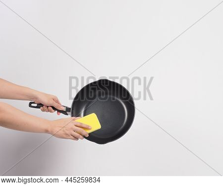 Hand Cleaning The Non Stick Pan With Handy Dish Washing Sponge