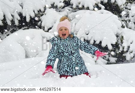 Caucasian Child In Winter Clothing Playing Outdoors