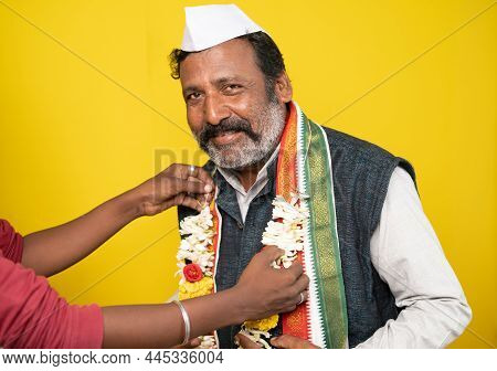 Politician Looking At Camera While Audience Offering Garland As Election Or Poll Victory - Concept O