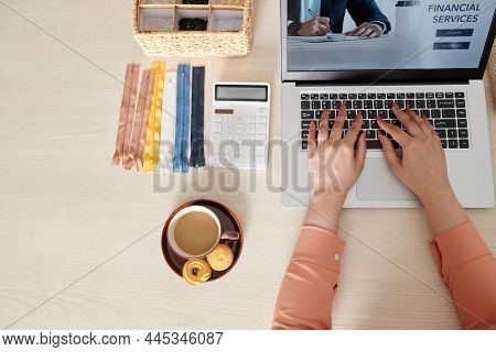 Hands Of Seamstess Having Cup Of Coffee With Cookies And Using Website Get Financial Services