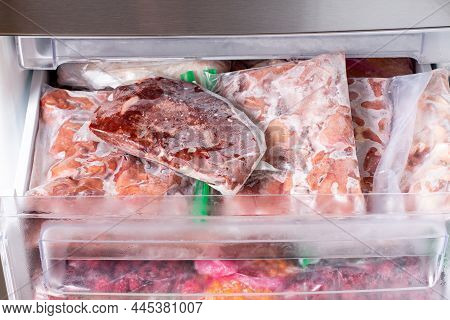 Frozen Meat And Meat Frozen Products In Plastic Package In The Freezer. Frozen Food. Concept Of Heal