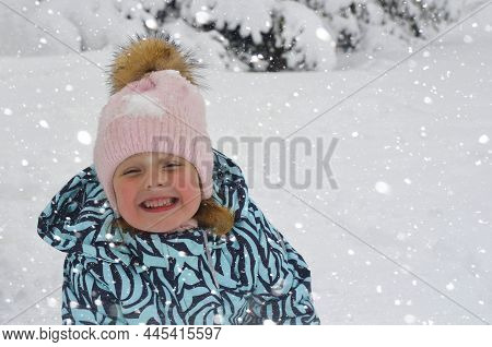 Caucasian Child In Winter Clothing Playing Outdoors