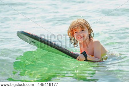 Kid Serfer. Catch The Wave. Extreme Sport Activity. Happy Child Playing In Th Sea Water.