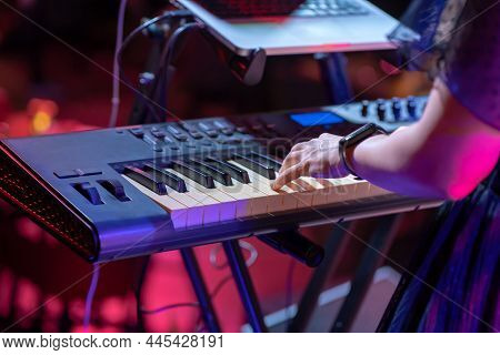 Close Up Of A Keyboardist Musician At Work At A Concert. Keyboardist Play Keyboard On Stage.