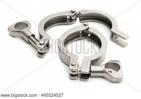 Two Clamps For Attaching Pipe Parts To Each Other On A White Background