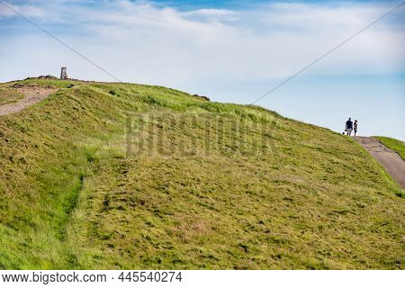 Hill Walkers Stroll Past Worcestershire Beacon At Malvern Hills, On A Summer Morn.