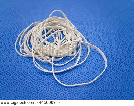 Closeup Image Of White Color Elastic Rubber Band In Blue Background