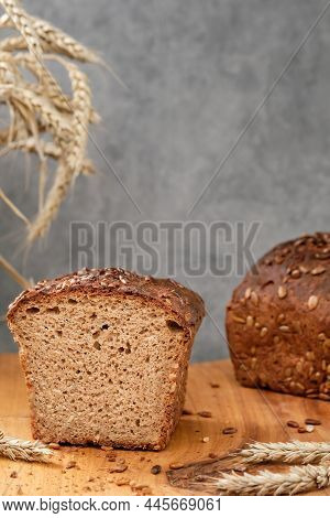 Loaf Of Wheat-rye Sourdough Bread With Sunflower Seeds On A Cutting Board. Freshly Baked Dark Bread 