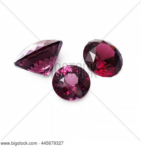 Three Faceted Red Rhodolite Garnets Isolated On White Background.