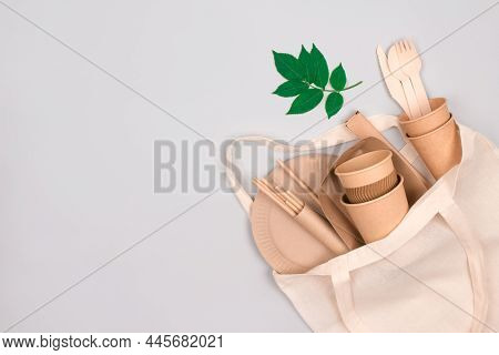 Eco-friendly Tableware - Kraft Paper Cups And Containers In White Cotton Bag On Gray Background With