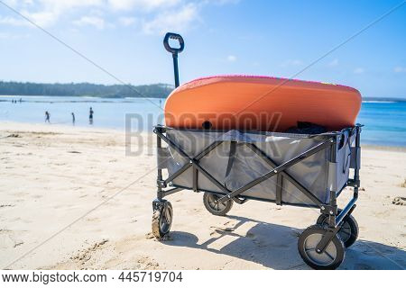 Outdoor Beach Cart Wagon On A Sandy Beach Near The Ocean. Family Vacation Holidays