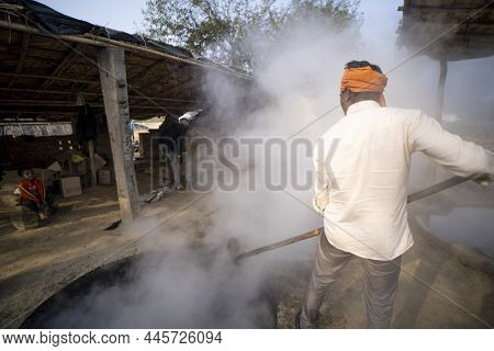 Delhi, India- January 12 2022- Indian Men Making Jaggery Out Of Sugarcane Juice In Uttar Pradesh. Me