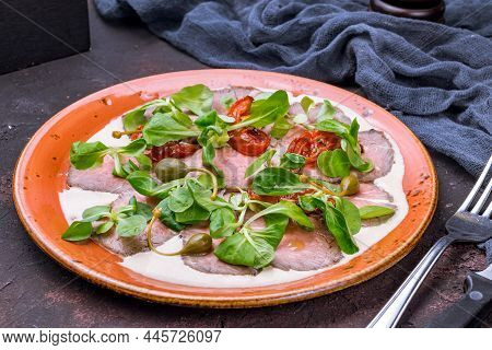 Vitello Tonato On A Plate On Dark Stone Table