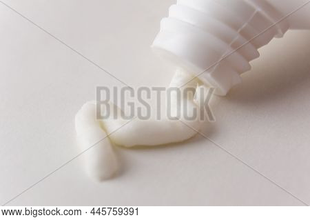 Cream, Ointment Is Squeezed Out Of A White Tube. The White Toothpaste Is Squeezed Out Of The Package