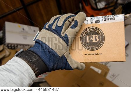 Frankfurt, Germany - Dec 10, 2021: Male Hand In Protection Glove Holding In Warehouse Farrow And Bal