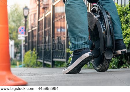 The Legs Of A Young Woman Ready To Ride An Electric Unicycle, Abbreviated Euc. An Unrecognizable Wom