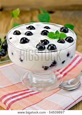Yogurt Is Thick With Black Currants And Spoon On The Board