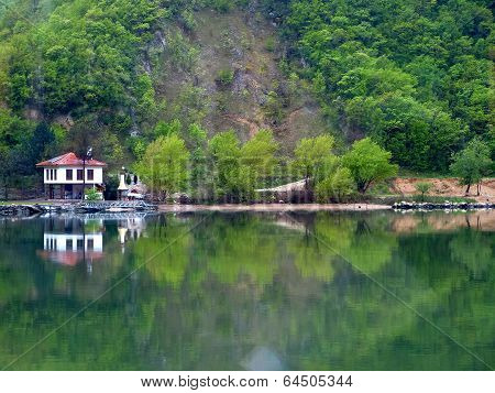 Buildings and trees reflected in water