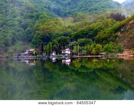 Buildings and trees reflected in water