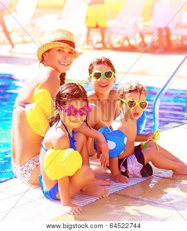 Big cheerful family having fun on beach resort, active lifestyle, spending time together near poolside, summer vacation and traveling concept