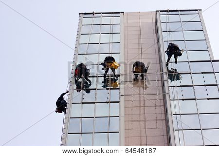 Men cleaning windows on a corporate bouilding