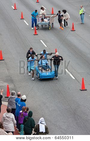 Teams Push Beds Down Street In Unique Fundraiser