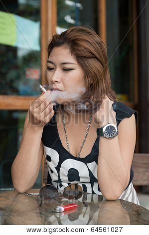 Young Asian Woman Smoking the Cigarette outside
