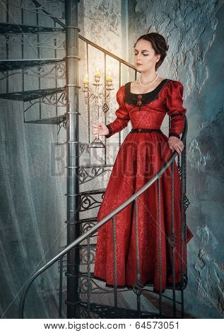 Beautiful Woman In Medieval Dress With Candelabrum