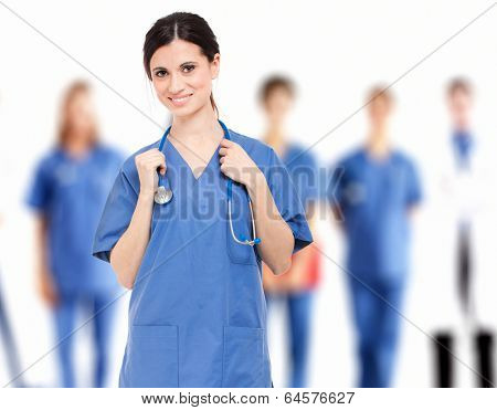 Portrait of a smiling nurse in front of her medical team 
