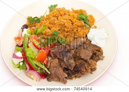 Roast lamb kuzu tandir, served with bulgur pilaf and a tossed Turkish salad, all mainstays of Ottoman cuisine