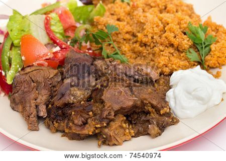 roast lamb kuzu tandir, served with bulgur pilaf and a tossed Turkish salad, all mainstays of Ottoman cuisine