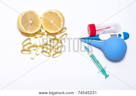 lemon, pills, tester, lavement, injecter and thermometer isolated on white