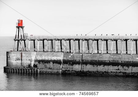 Scenic view of Whitby Pier in sunny autumn day, UK