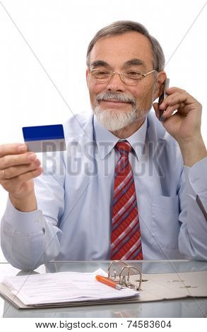 Businessman making a credit card purchase by phone