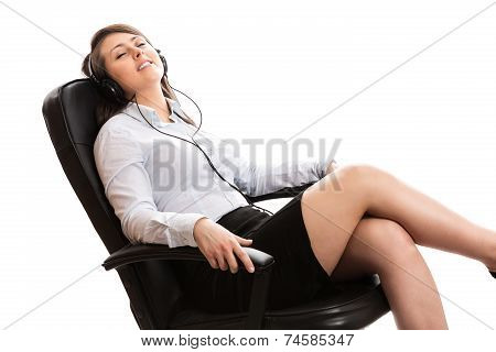 Support operator with headset relaxing on office chair
