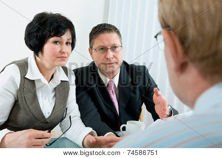 woman and her lawyer in conversation with husband during divorce process