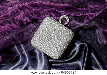 White Clutch Inlaid Diamonds On Silk Background