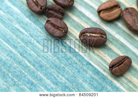 Coffee beans on blue wood texture to background