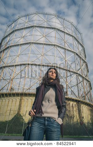 Beautiful Young Brunette Posing In Front Of A Gasometer