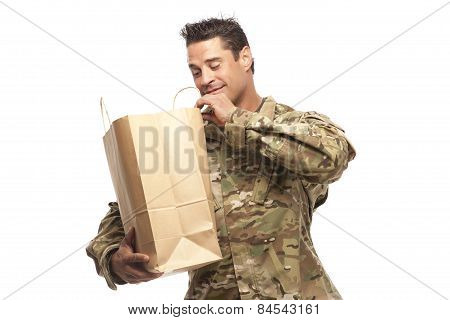 Happy Army Soldier Looking Into His Shopping Bag